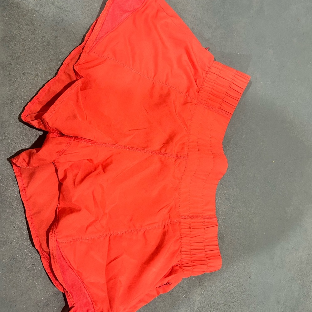 Lululemon Coral/Red shorts. Perfect condition aside from one tiny pen spot